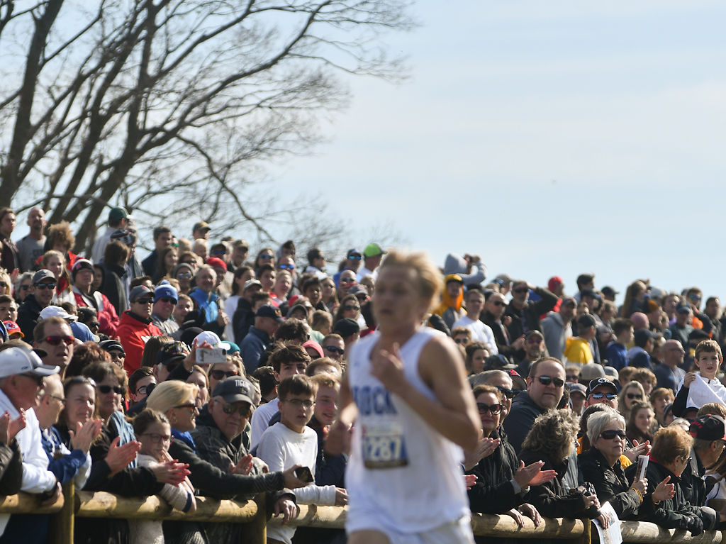 Spectators watch as a runner passes by